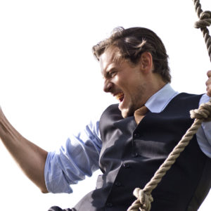 Strong, able businessman climbing ropes