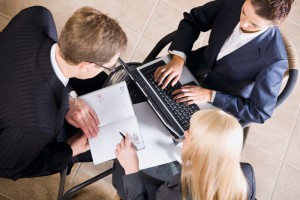 Businesspeople gathered around a table for a meeting and brainstorming