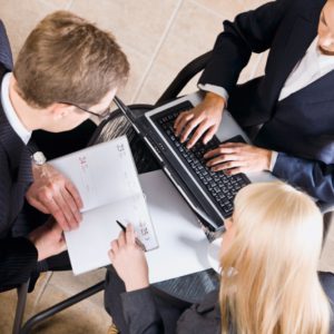 Businesspeople gathered around a table for a meeting and brainstorming