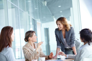 Image of four businesswomen interacting at meeting