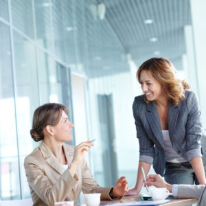 Image of four businesswomen interacting at meeting