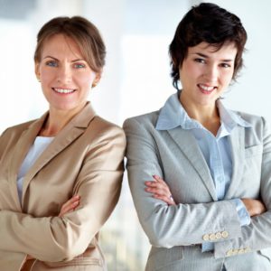 Portrait of two strong women in business standing shoulder to shoulder expressing unity